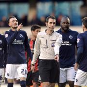 Championship referee David Coote is surrounded by Millwall players after awarding a Bournemouth penalty recently. Coote, who takes charge of Wanderers on Saturday, could soon be professional