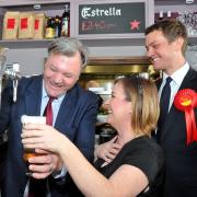 GLASS HALF EMPTY: Ed Balls struggles to pour a pint at the Barista Cafe Bar in Bury last weekend prior to his visit to the Macron