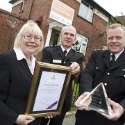 Cllr Elaine Sherrington, Bolton Fire Station Commander Brian Wiggans and Chief Supt Dave Lea of Bolton Police with the award