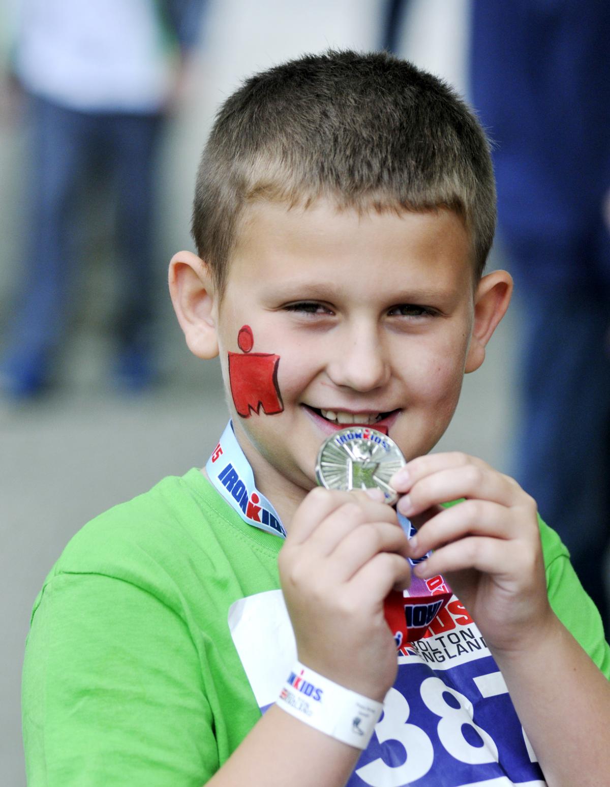 11-year-old Ryan McGill shows off his medal.