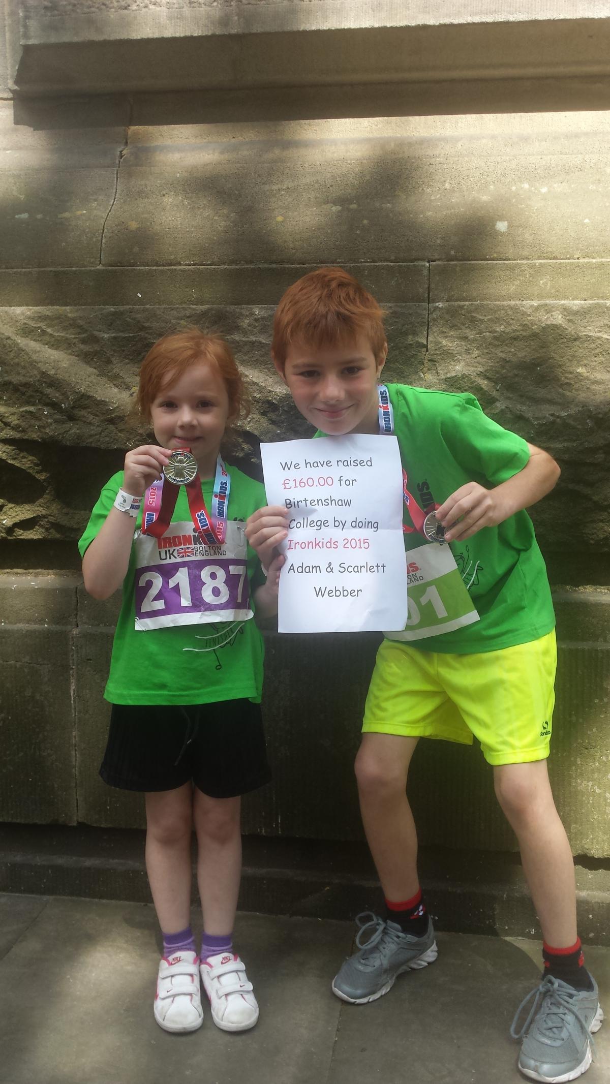 10-year-old Adam Webber and sister Scarlett, aged five, celebrate their fundraising efforts.