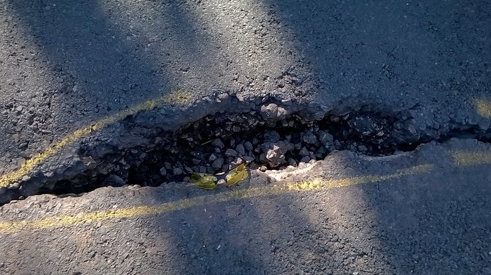 Triathlon coach says he could have been killed by 'giant pothole'