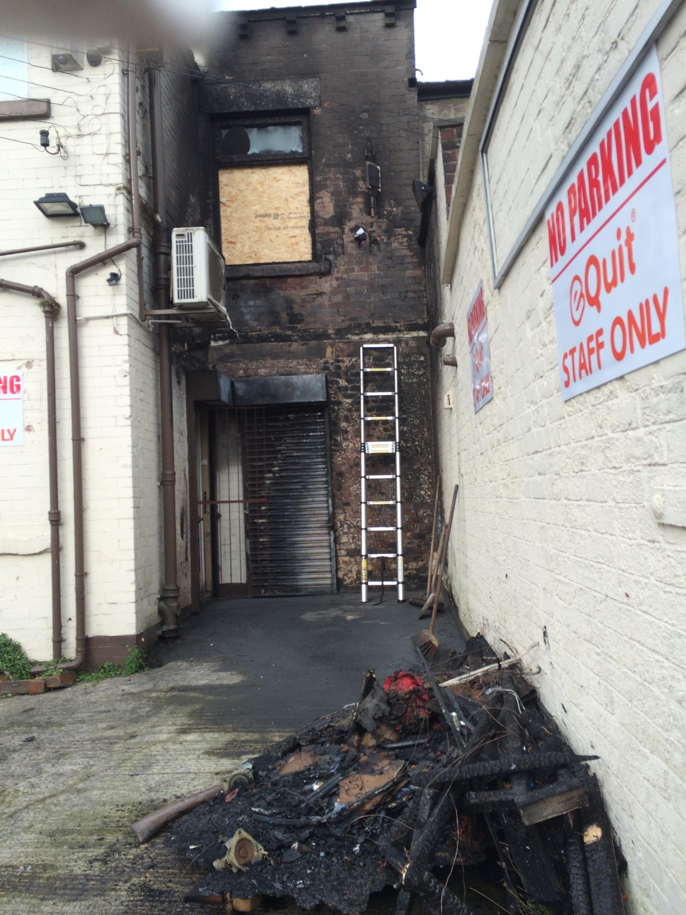 Investigation underway into cause of fire which spread to the outside of a shop