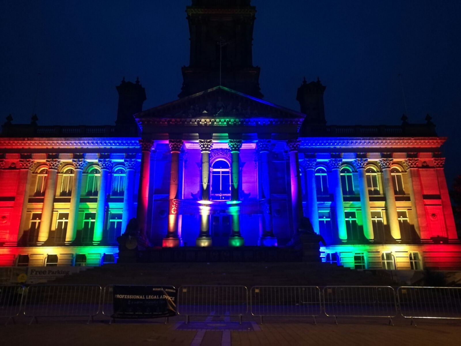 Bolton Town Hall lit up in colours of the Rainbow Flag