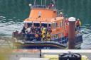 A group of people thought to be migrants are brought in to Dover, Kent, onboard the RNLI Dover Lifeboat following a small boat incident in the Channel. (Gareth Fuller/PA)