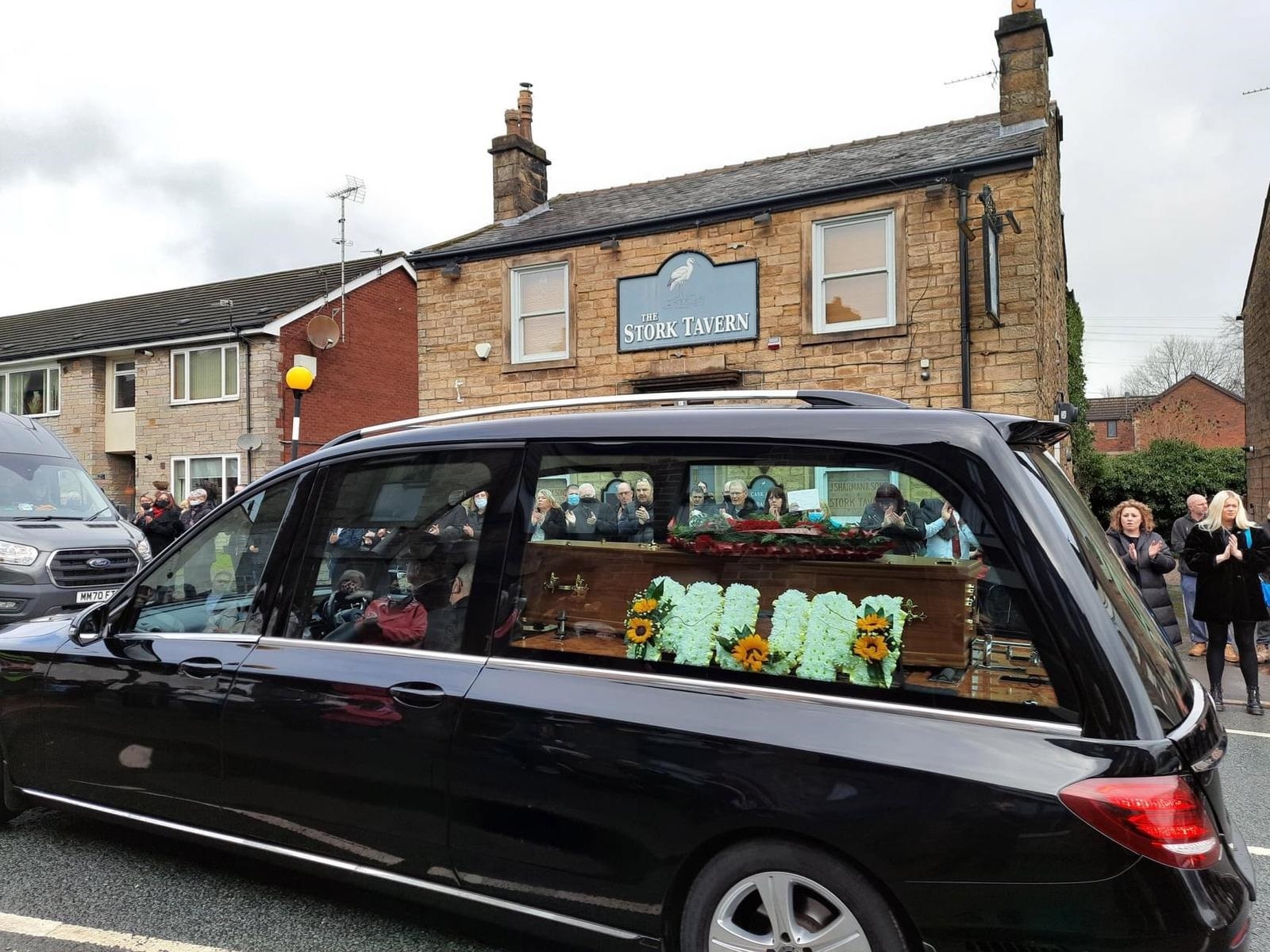 Jans coffin is carried by the funeral hearse outside The Stork Tavern in Halliwell