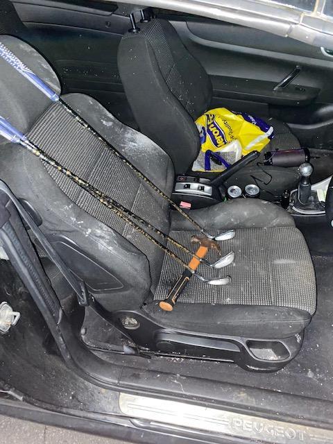 Items including golf clubs in a car