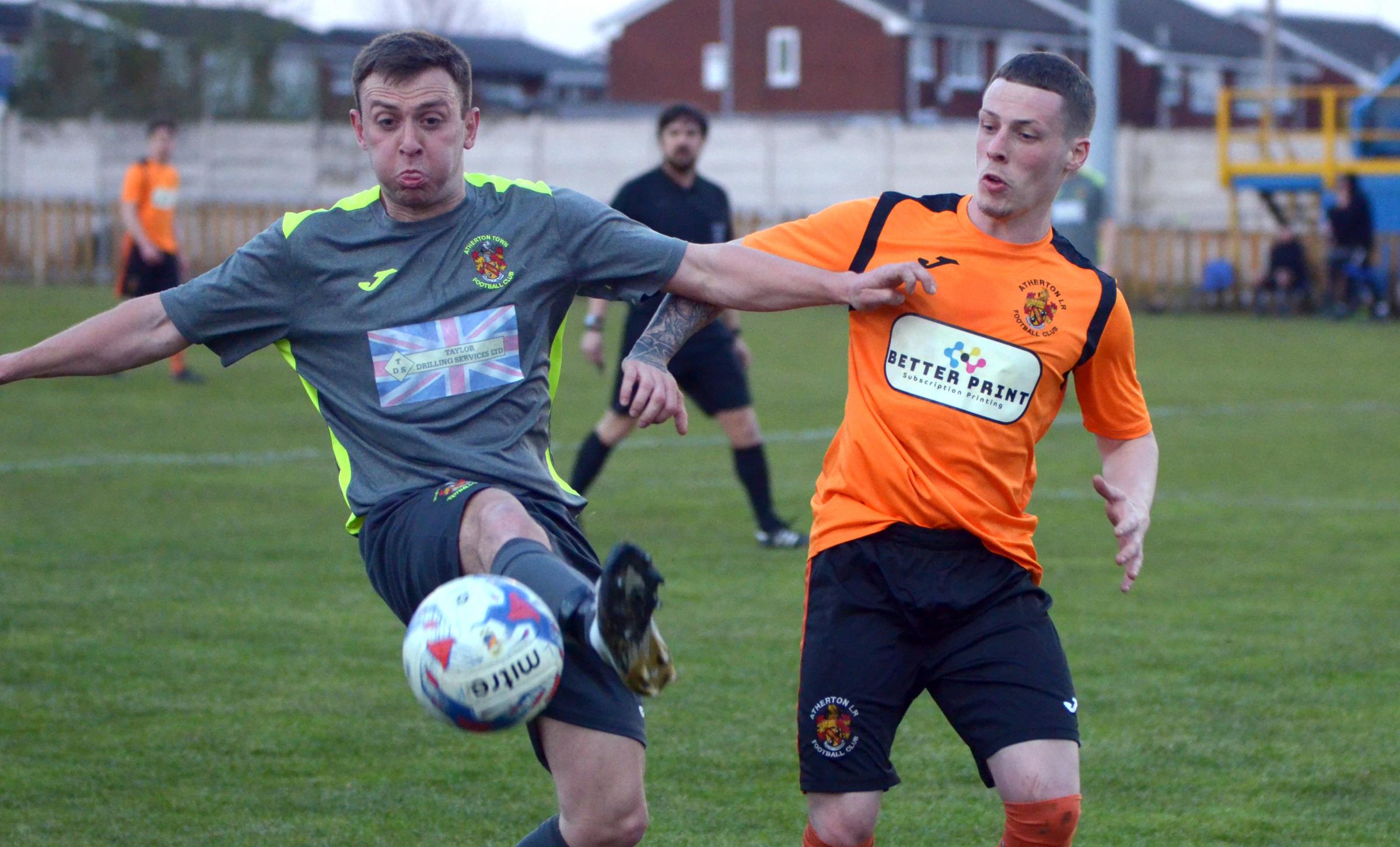 Action from the meeting between Atherton LR, in orange, and Atherton Town in the Bolton Hospital Cup. Picture: James Lobley 