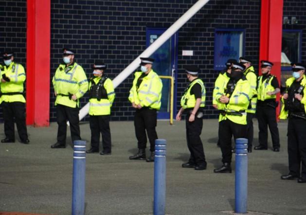 Police line up after Saturday's game to clear trouble at the University of Bolton Stadium