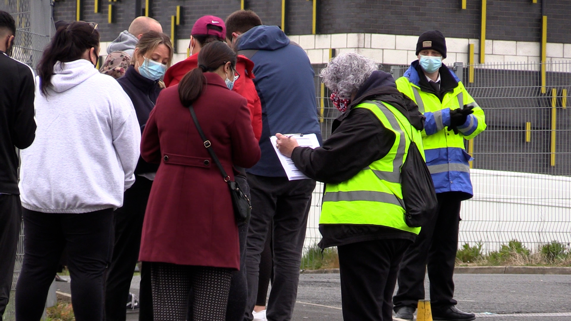 People queue for the vaccination centre at the Essa Academy in Bolton. The Indian coronavirus variant has been detected in a number of areas in England, including Bolton, which are reporting the highest rates of infection, data suggests. Picture date: