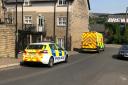 A police car and an ambulance outside an address on Square Street in Ramsbottom