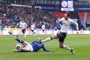 Bolton Wanderers' Gethin Jones crosses the ball despite the attentions of Ipswich Town's Harry Clarke