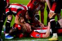 Brentford’s Ben Mee (floor, centre) celebrates with his team-mates after scoring their side’s second goal of the game during the Premier League match at the Gtech Community Stadium, London. Picture date: Saturday December 2, 2023.