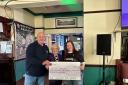 The cheque being presented by The Vulcan Inn
