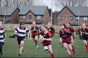 Bolton Amazons’ Sammie Makin with the ball, backed up by team-mates (all in red and black) Sofia Reis-Coop, Betty Weall, Holly Turner, Iona Barnes and Jasmine Cox