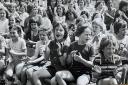 Cheering on their schoolmates, pupils from Daisy Hil CE School at the annual sports day in June 1975