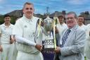 Padiham skipper Toby Burrows receives the NWCL Hamer Cup from Frank Hinks, of sponsors JD Consultancy, last season. Picture by Harry McGuire