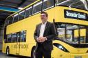 Greater Manchester mayor Andy Burnham next to one of the new Bee Network buses (Image: TfGM)