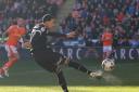 Josh Dacres-Cogley fires a shot at goal for Wanderers at Blackpool