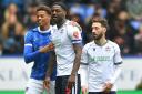 Bolton Wanderers' Ricardo Santos hugs Portsmouth's Kusini Yengi