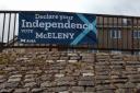 The banner promoting the campaign of Chris McEleny has been placed on railings in Inverclyde