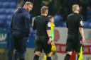Evatt speaks to referee Josh Smith after a controversial game against Burton