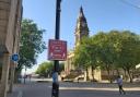 A coronavirus social distancing sign in front of Bolton Town Hall in Victoria Square