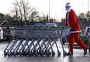 A man dressed as Father Christmas collects trolleys at a Morrisons supermarket in Belle Vale, Liverpool..