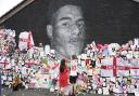 A mural of Marcus Rashford which had been defaced is adorned with messages of support (Danny Lawson/PA).