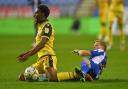 Dapo Afolayan is fouled in the Carabao Cup game at Wigan Athletic.