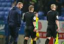 Evatt speaks to referee Josh Smith after a controversial game against Burton