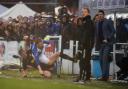 Rob Holding thunders into a challenge at Eastleigh as Wanderers boss Neil Lennon looks on