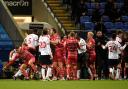 Wanderers and Doncaster Rovers players clash in the recent League One game