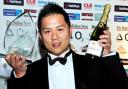TOASTING SUCCESS: Peter Wu, of The Chinese Buffet, with the Business Person of the Year award — and champagne!