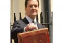 Chancellor George Osborne holds his famous ministerial red box ahead of his emergency Budget