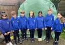 Year 5 and 6 Children of the school's Eco Council in front of the vandalised greenhouse