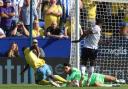 Bolton Wanderers' James Trafford saves at the feet of Sheffield Wednesday's Dennis Adeniran with Bolton Wanderers' Ricardo Santos close by