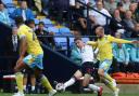 Bolton Wanderers' Conor Bradley plays a forward pass under pressure from Sheffield Wednesday's Barry Bannan