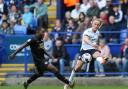 Bolton Wanderers' Kyle Dempsey crosses the ball despite the attentions of Peterborough United's Jeando Fuchs
