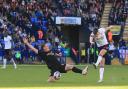 Bolton Wanderers' George Thomason shoots for goal despite the attentions of Peterborough United's Ben Thompson but it was blocked