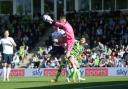 Forest Green Rovers' Luke McGee collides with Bolton Wanderers' George Johnston