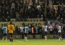 Wanderers' players salute the crowd after a 0-0 draw at Cambridge United