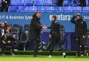 Ian Evatt shakes the hand of interim Pompey boss Simon Bassey after the final whistle