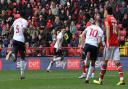 Aaron Morley races away to celebrate his goal for Wanderers at Charlton