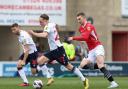 Bolton Wanderers' Kyle Dempsey runs with ball with Morecambe's Ashley Hunter close by