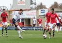 Bolton Wanderers' Josh Sheehan shoots for goal despite the attentions of Morecambe's Jacob Bedeau but it was saved