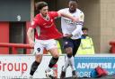 Morecambe's Cole Stockton holds off the challenge from Bolton Wanderers' Ricardo Santos