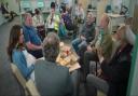 The Monty men and Yvonne sit around a table in the 'Sheffield Job Hub', played by Bolton's former Specsavers in Crompton House