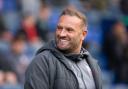 Wanderers boss Ian Evatt flashes a smile during the 1-0 win against Barrow