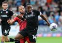 Victor Adeboyejo in action for Wanderers against Cheltenham's Charlie Kirk